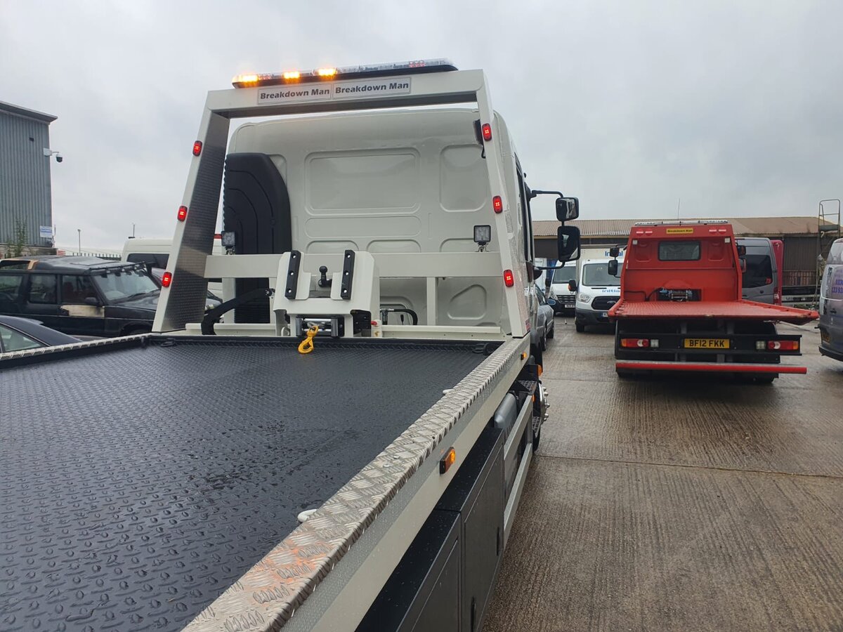 Breakdown Man recovery truck with the bed lowered, ready to load