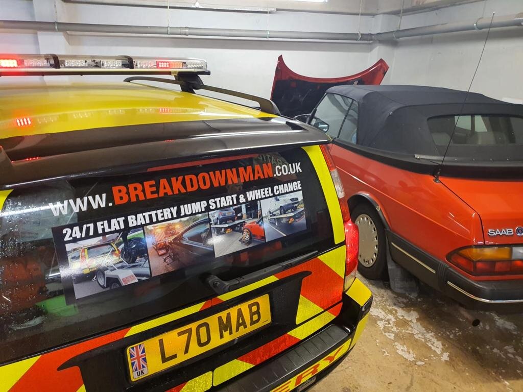 Branded Breakdown Man recovery truck (L70 MAB) parked beside a red Saab convertible with bonnet open ready for a jump start.