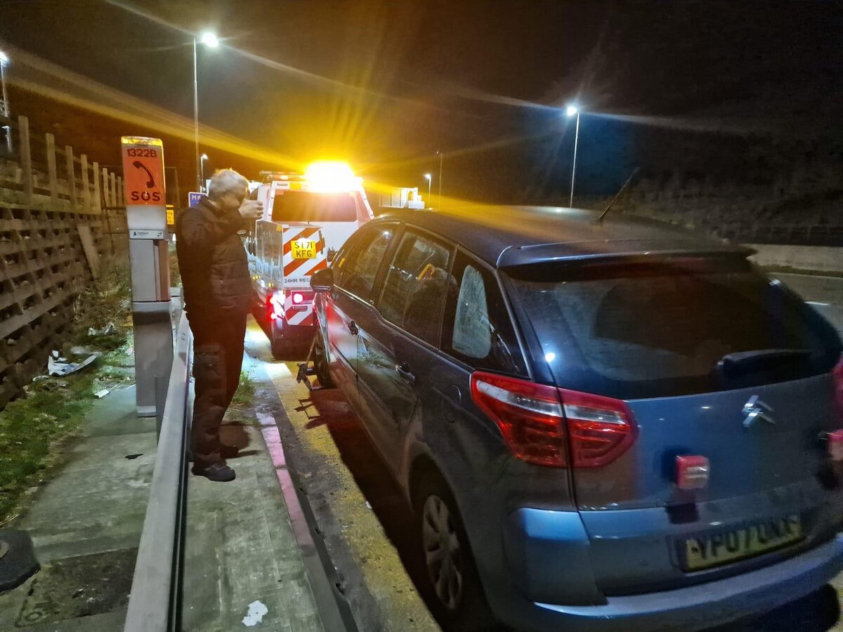 Silver Citroën C4 Picasso on Breakdown Man's recovery truck at SOS marker 1322B during a night-time motorway recovery.