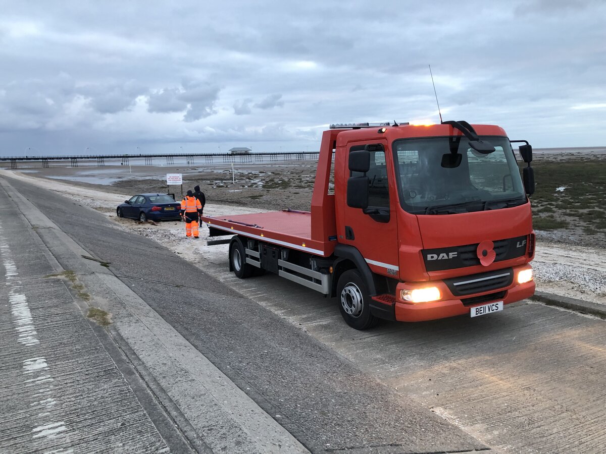 Breakdown Man recovery truck on a coastal road, the kind of touring route caravans break down on