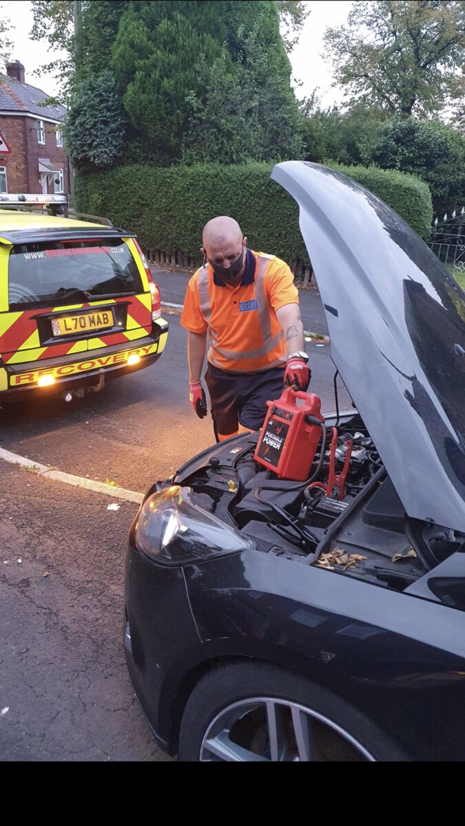 Simon at a flat-battery jump-start callout on a residential street with the Breakdown Man recovery truck behind.