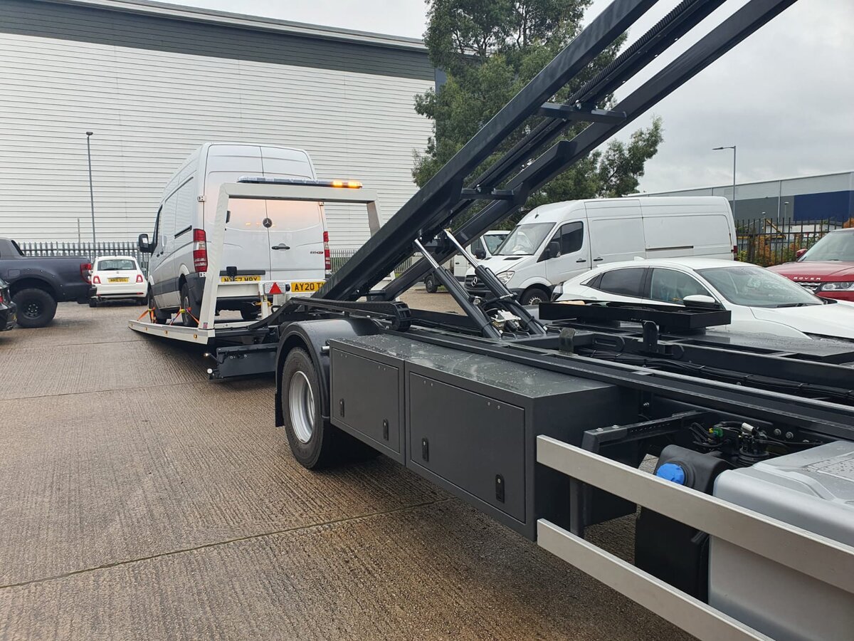 White Mercedes Sprinter panel van loaded onto the Breakdown Man recovery truck at an industrial estate
