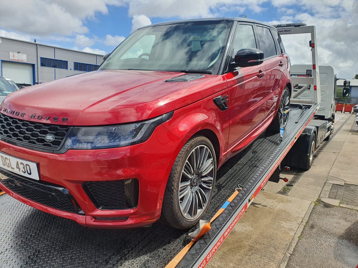 Red Range Rover Sport loaded onto the Breakdown Man flatbed at the depot.