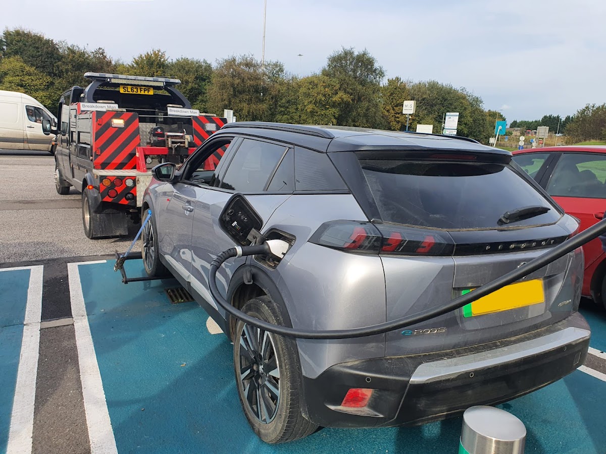 Towing a Peugeot e-3008 from an EV charging point.
