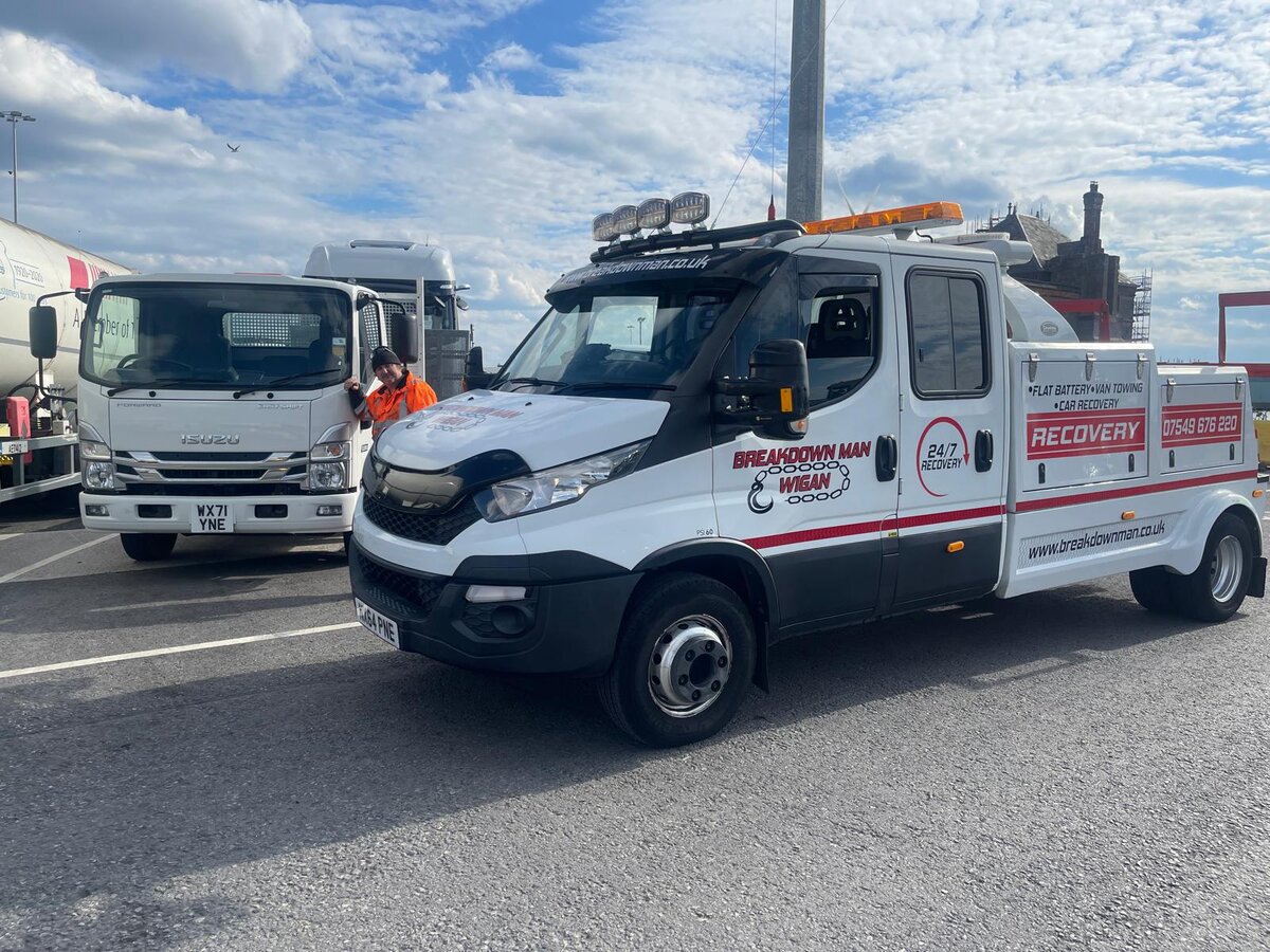 White Breakdown Man Wigan Iveco 24/7 Recovery truck on the road with another recovery truck in the background, ready for the next Wigan-area callout.