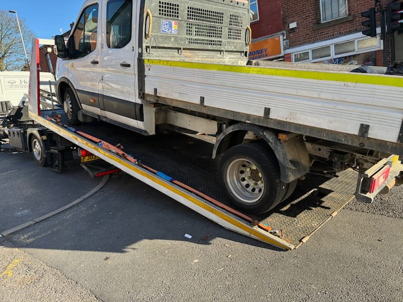 Breakdown recovery truck loading a vehicle.