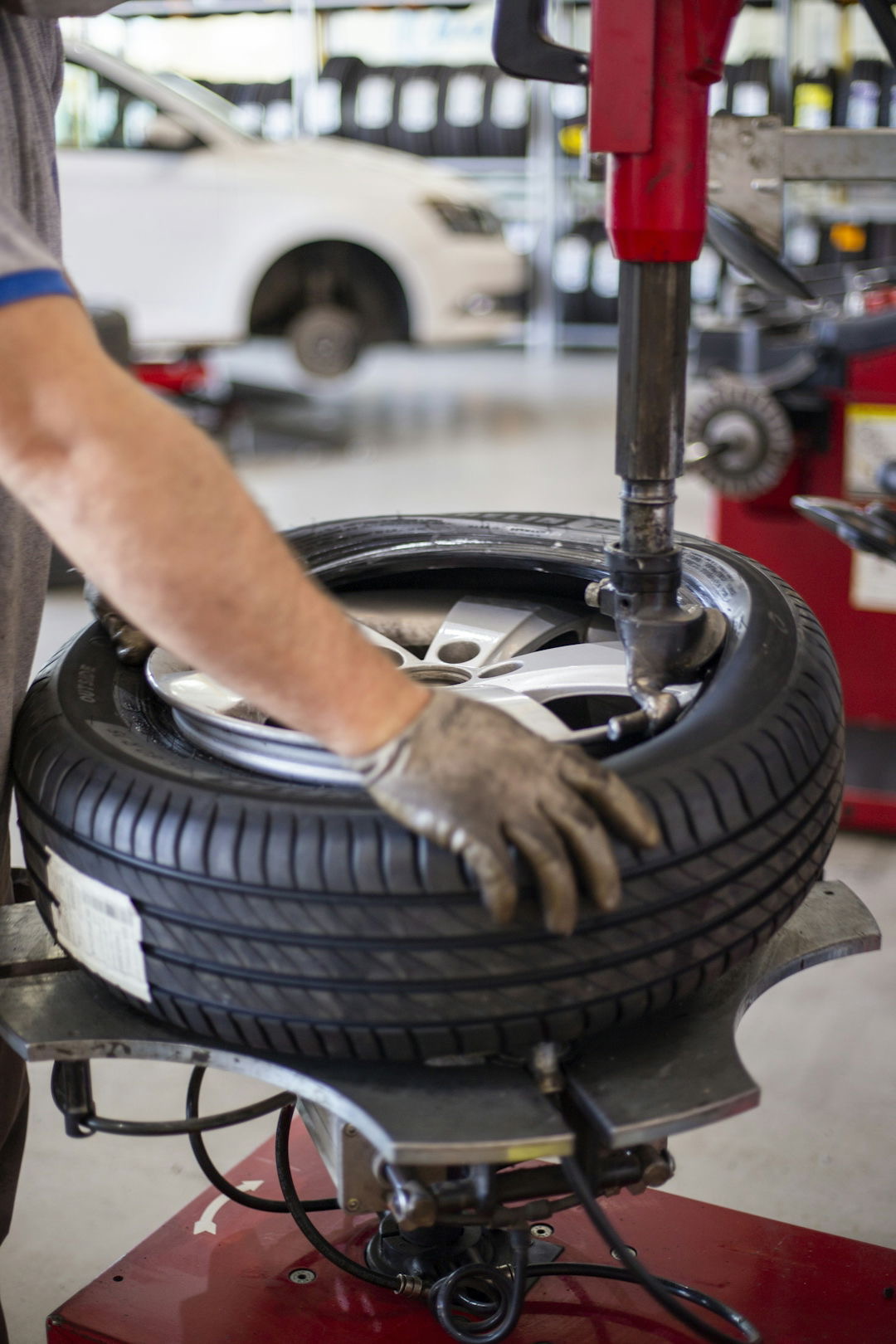 A tyre being mounted on a workshop tyre machine.